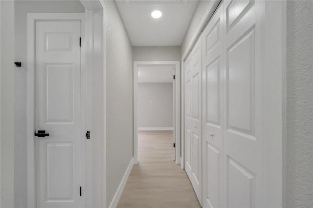 corridor with light wood-type flooring