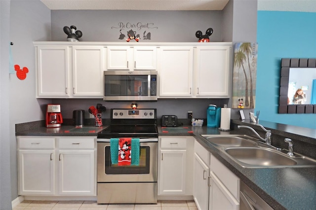 kitchen featuring white cabinetry, sink, and appliances with stainless steel finishes