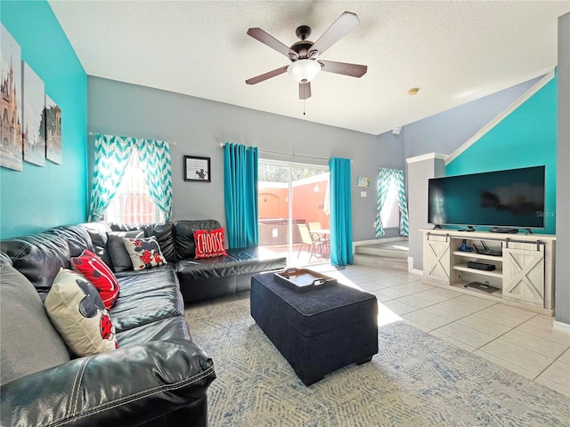 living room featuring light tile patterned floors, a textured ceiling, and ceiling fan