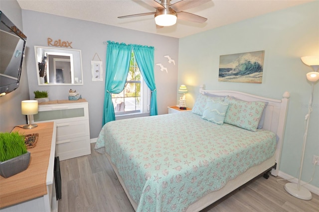 bedroom with ceiling fan and light hardwood / wood-style flooring