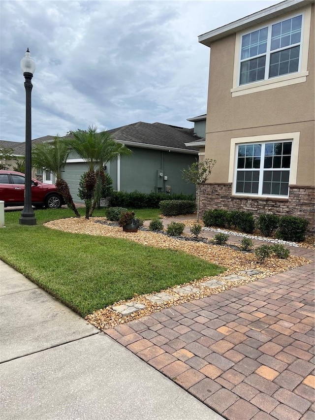 view of side of property with a lawn