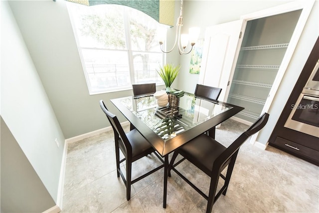 dining space featuring a healthy amount of sunlight and a notable chandelier