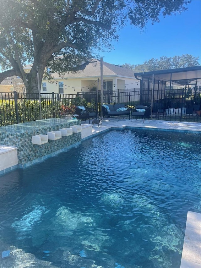 view of pool featuring pool water feature and a patio area