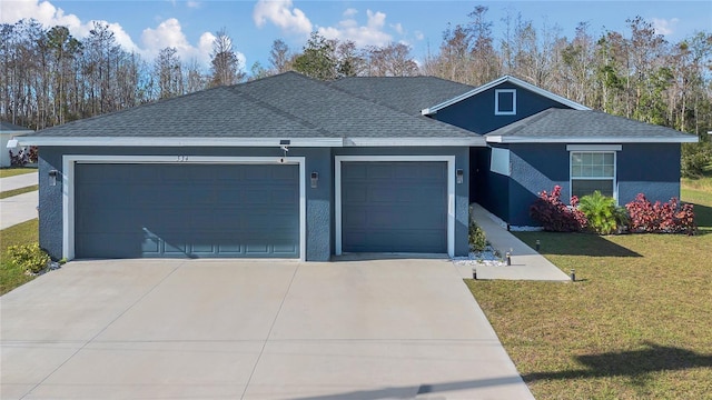 view of front of home with a front yard and a garage