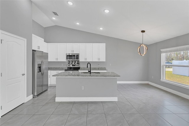 kitchen featuring a center island with sink, light stone countertops, appliances with stainless steel finishes, white cabinets, and pendant lighting