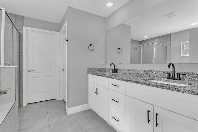 bathroom with vanity, tile patterned flooring, and a shower with door