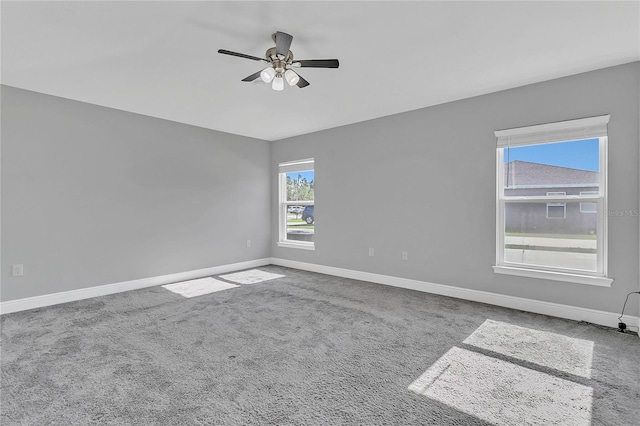 empty room with ceiling fan and carpet floors