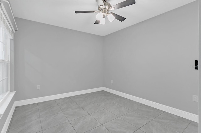 tiled spare room with ceiling fan