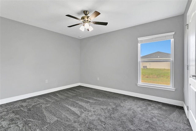 empty room with dark carpet and ceiling fan