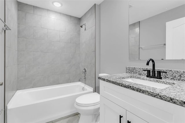 full bathroom featuring toilet, vanity, and tiled shower / bath