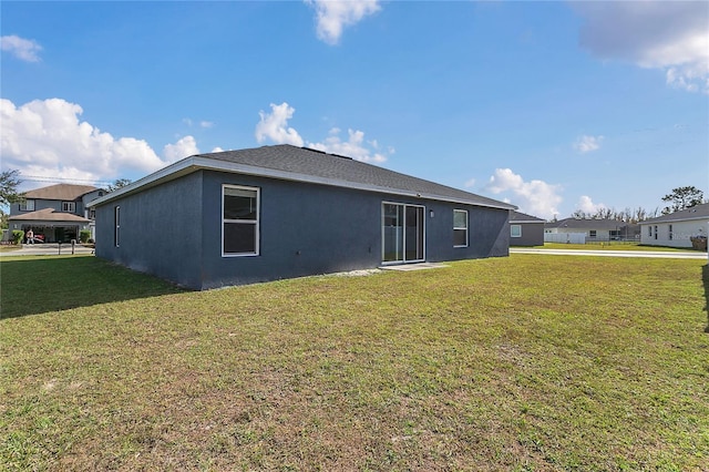 rear view of property featuring a yard