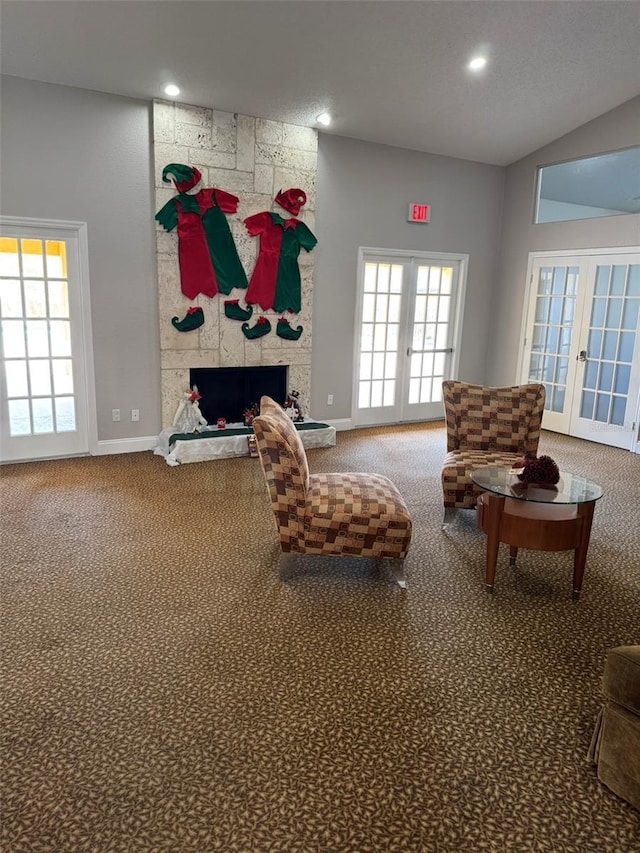 sitting room with a fireplace, french doors, and carpet