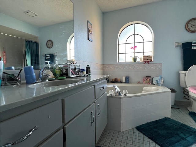 full bathroom with vanity, a textured ceiling, plus walk in shower, tile patterned flooring, and toilet