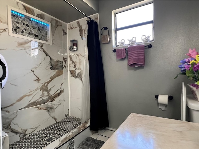 bathroom featuring tile patterned floors and walk in shower