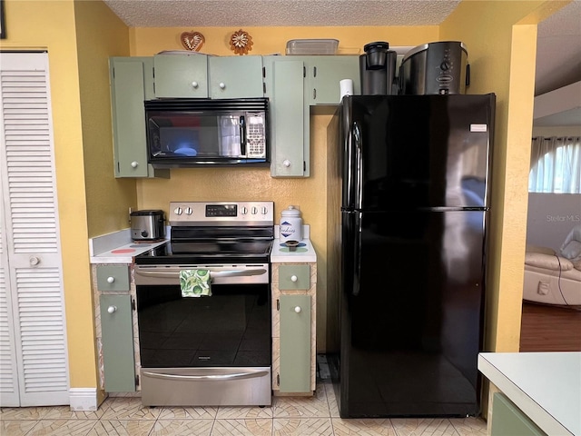 kitchen featuring black appliances, a textured ceiling, and green cabinetry