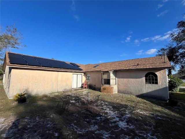 back of house with solar panels