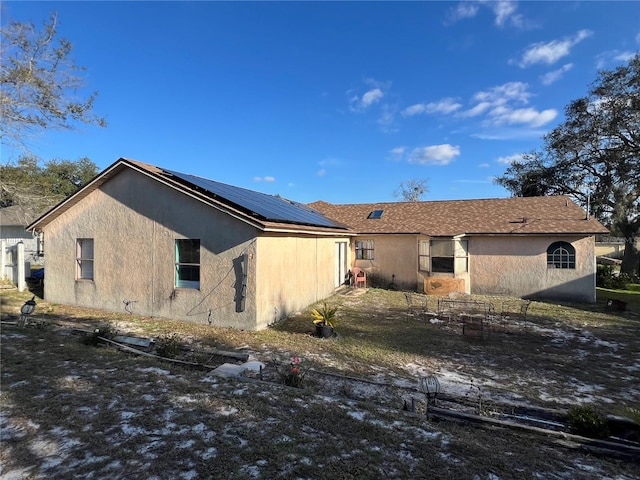 back of house with solar panels