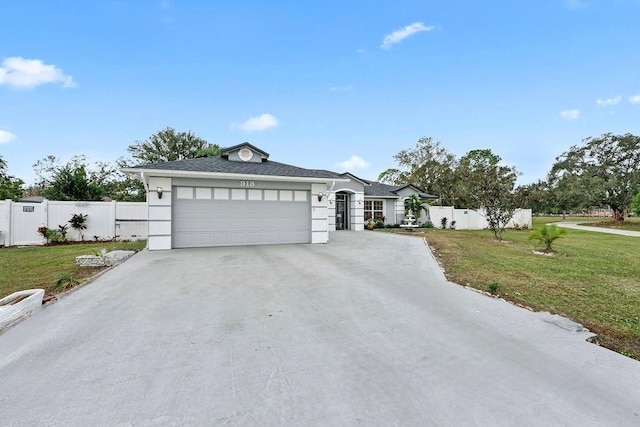 view of front of property featuring a front lawn and a garage