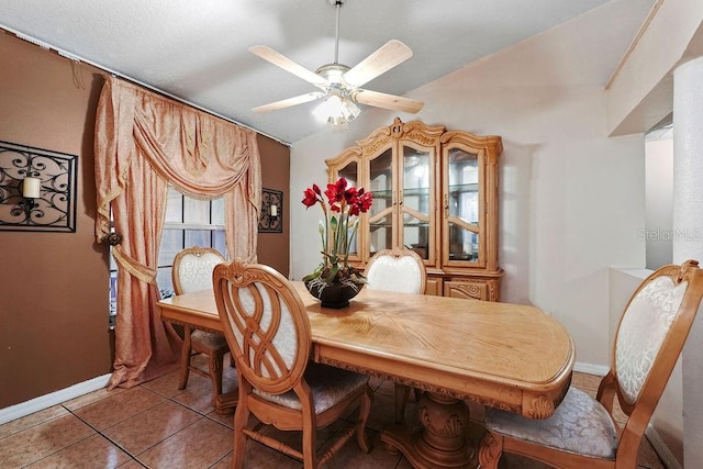 tiled dining room featuring ceiling fan