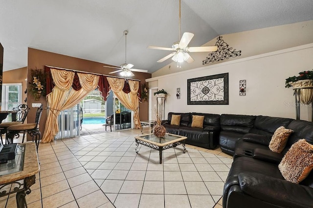 living room featuring ceiling fan, light tile patterned floors, and lofted ceiling