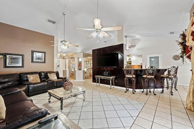 living room featuring light tile patterned floors, high vaulted ceiling, and ceiling fan