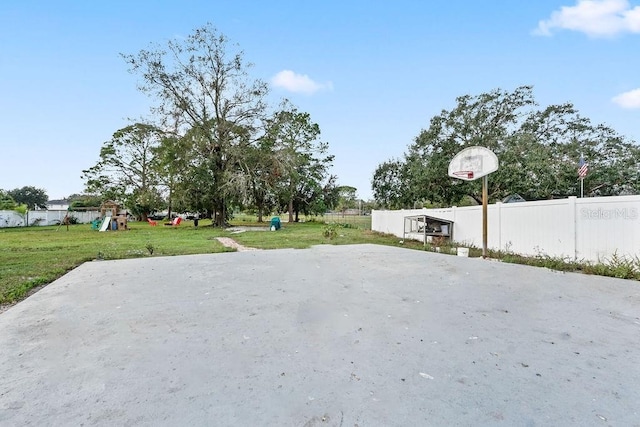 view of patio featuring basketball court and a playground