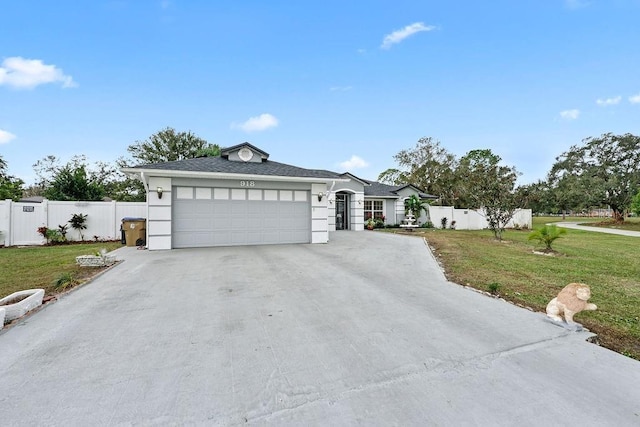 ranch-style house featuring concrete driveway, a front lawn, an attached garage, and fence