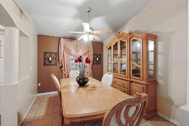 dining room featuring light tile patterned floors, ceiling fan, decorative columns, and baseboards