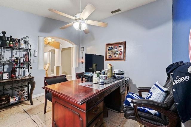 office space featuring arched walkways, ceiling fan, light tile patterned floors, and visible vents