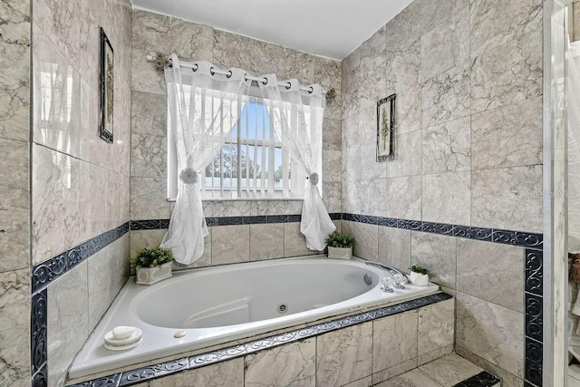 full bath with a tub with jets and tile walls