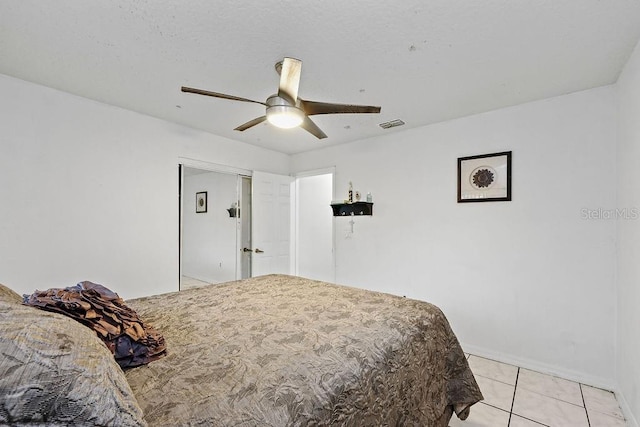 bedroom with visible vents, ceiling fan, baseboards, and light tile patterned floors