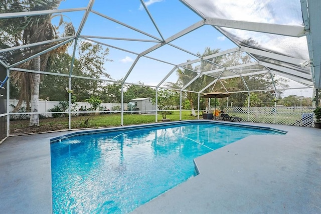 view of swimming pool featuring a fenced in pool, an outbuilding, glass enclosure, a shed, and a fenced backyard