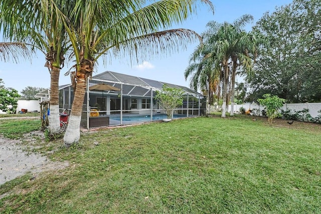 view of yard featuring a fenced in pool, a lanai, and a fenced backyard