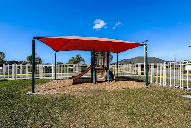 community play area with a yard and fence