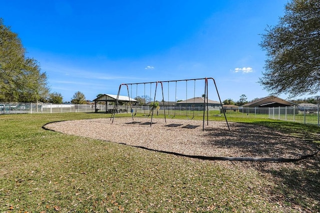 community play area featuring a yard, fence, and a gazebo