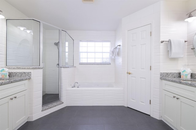 bathroom with tile patterned flooring, vanity, and independent shower and bath