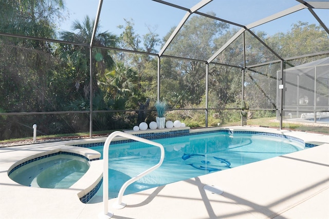 view of pool with glass enclosure, an in ground hot tub, and a patio