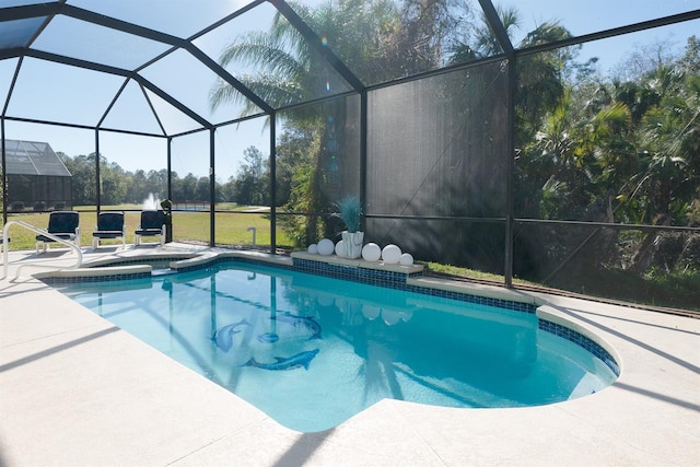 view of pool with glass enclosure and a patio