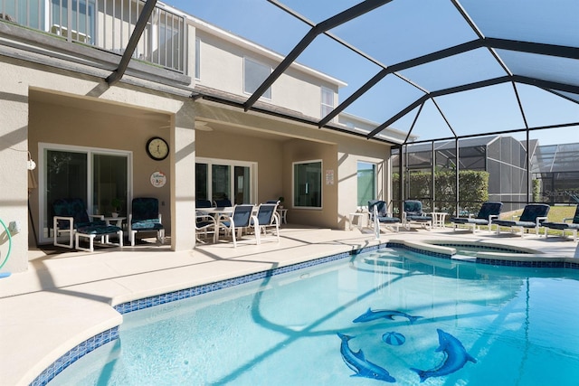 view of pool with glass enclosure, an in ground hot tub, and a patio