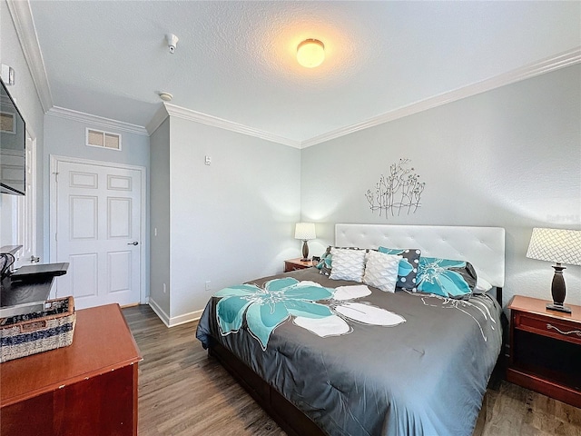 bedroom featuring hardwood / wood-style floors and crown molding