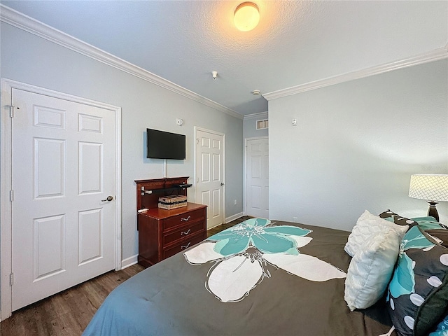 bedroom featuring dark hardwood / wood-style flooring and crown molding