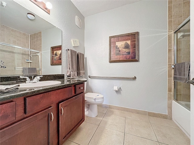 full bathroom with tile patterned floors, vanity, tiled shower / bath combo, and toilet