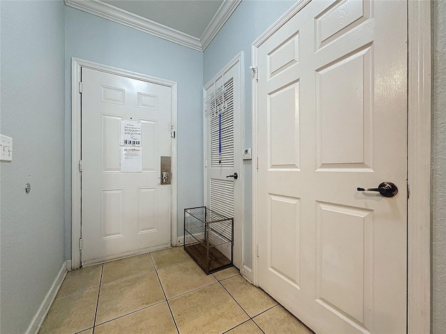 entryway with light tile patterned floors and ornamental molding