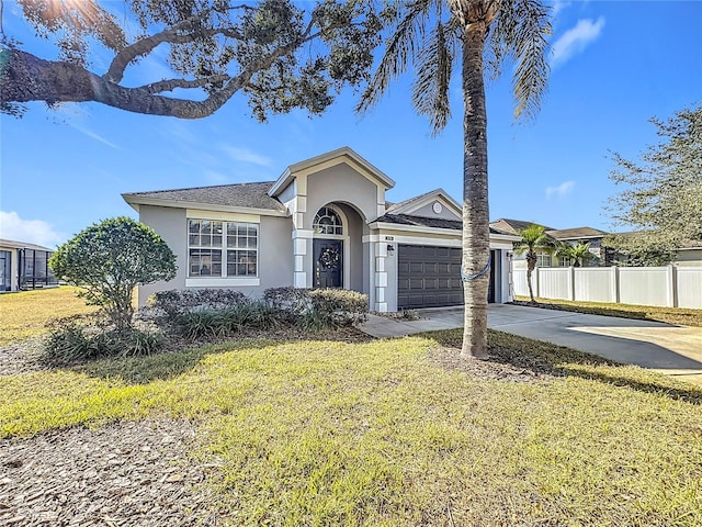 single story home with a garage and a front yard