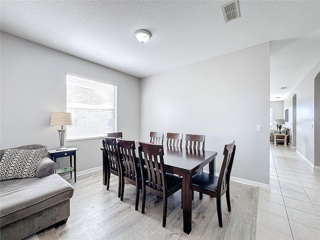 dining area featuring a textured ceiling