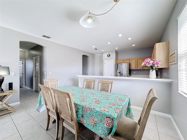 tiled dining area with a healthy amount of sunlight