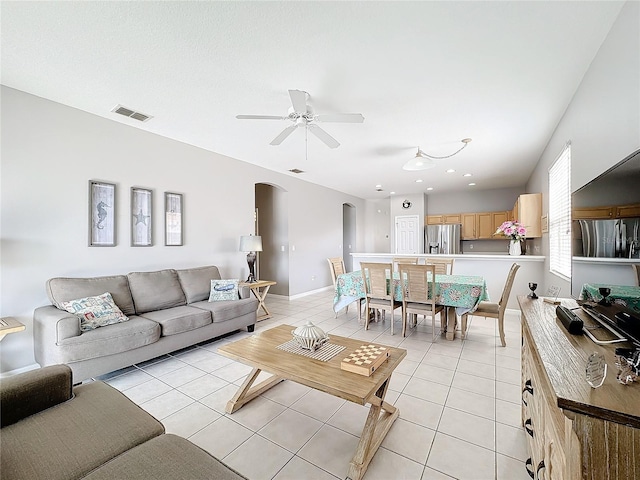 living room featuring ceiling fan and light tile patterned floors