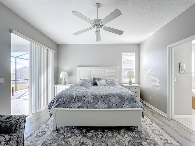 bedroom with a textured ceiling, access to outside, ceiling fan, and light hardwood / wood-style floors