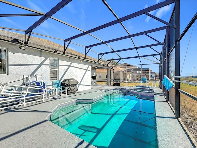 view of swimming pool featuring a lanai, a patio area, and an in ground hot tub