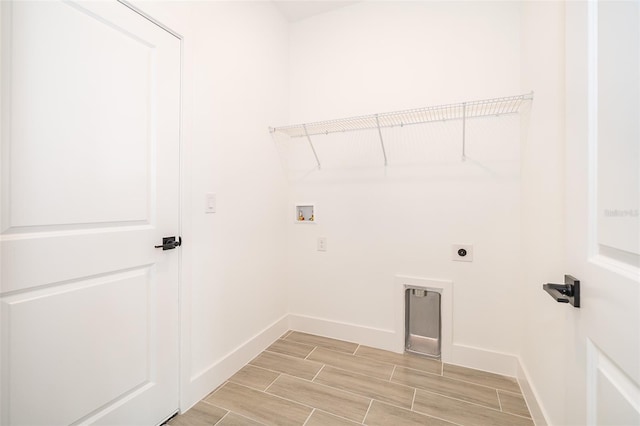 laundry room featuring laundry area, baseboards, hookup for an electric dryer, wood finish floors, and washer hookup